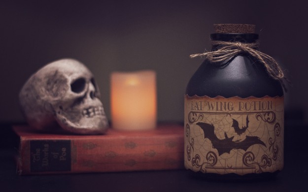 Spooky potion bottle book by Edgar Allan Poe candle and skull